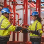 Engineer or technician work checking Fire suppression system and fire equipment. Engineer check red generator pump for water sprinkler piping and fire alarm control system